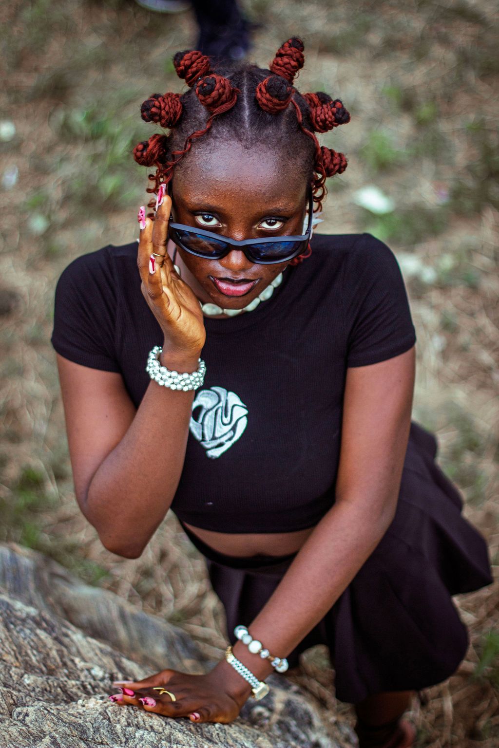 Cover portrait — a creative with red bantu knots and sunglasses