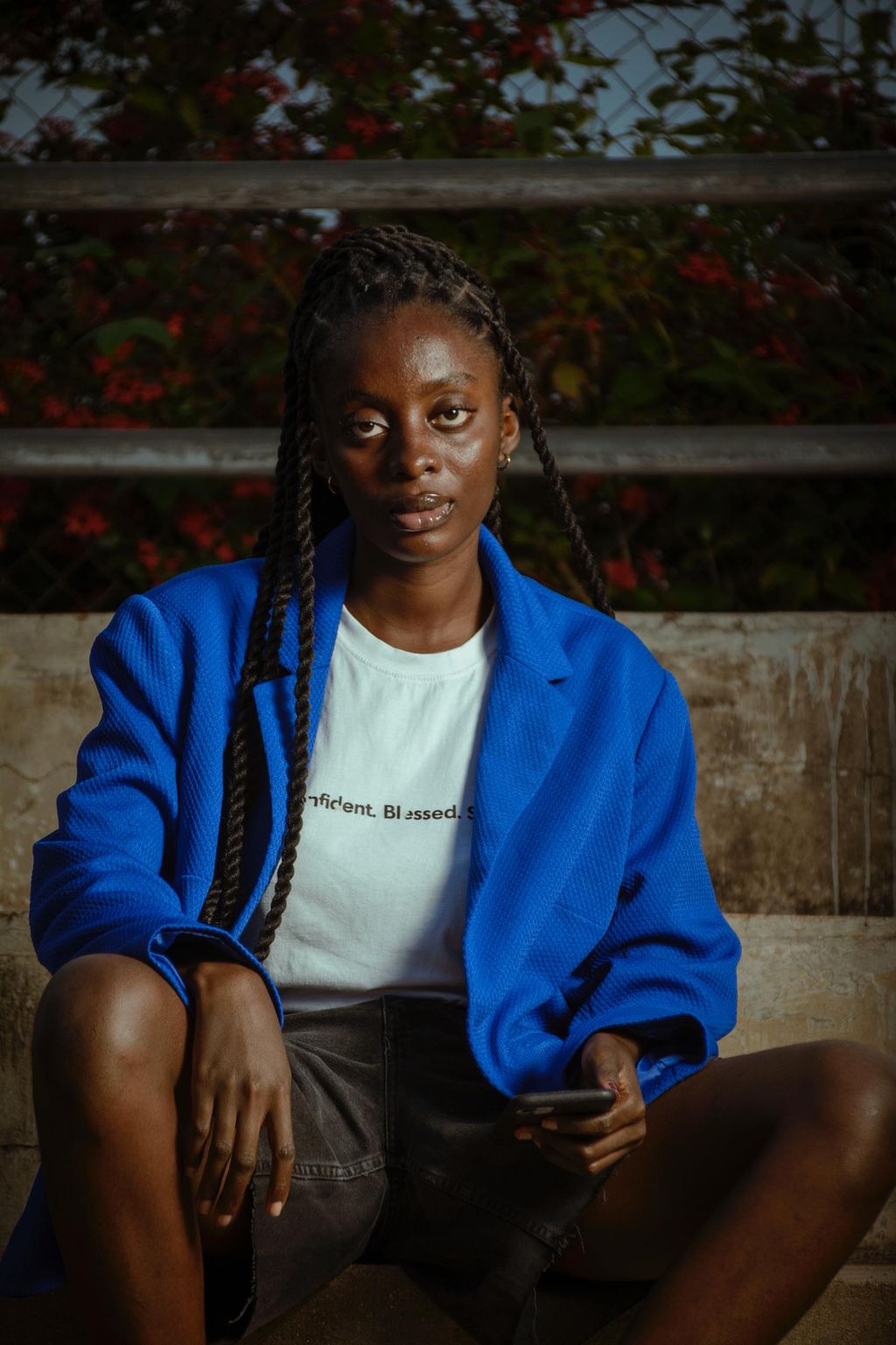 Cover portrait — a creative in a blue jacket seated on concrete steps