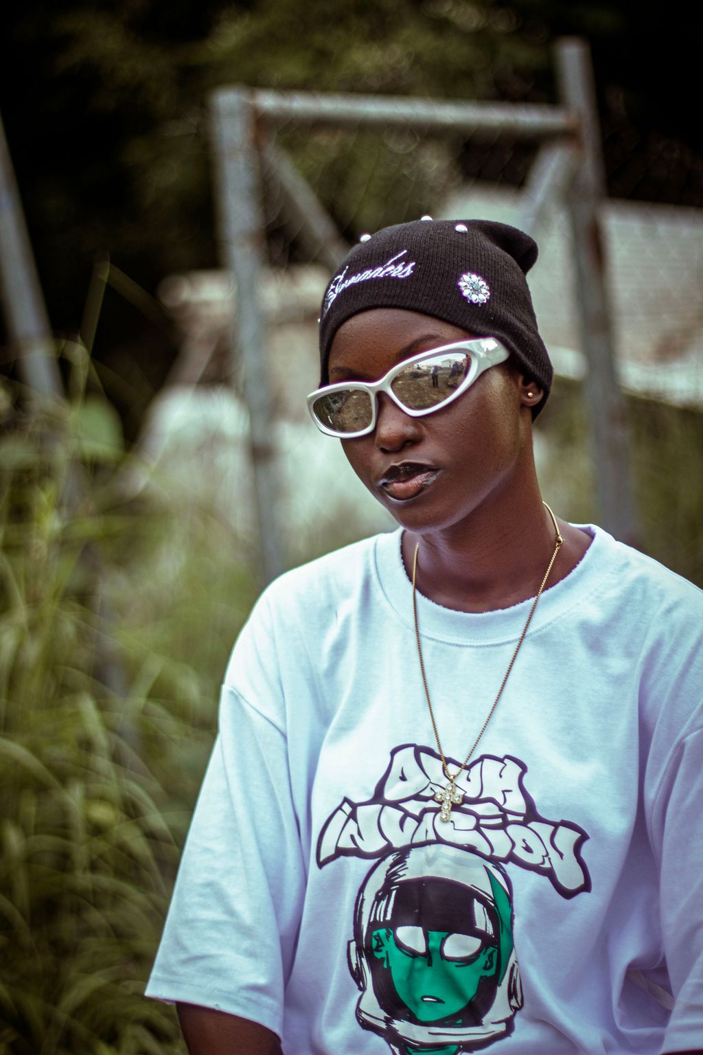 Cover portrait — a creative in a graphic white tee and white sunglasses