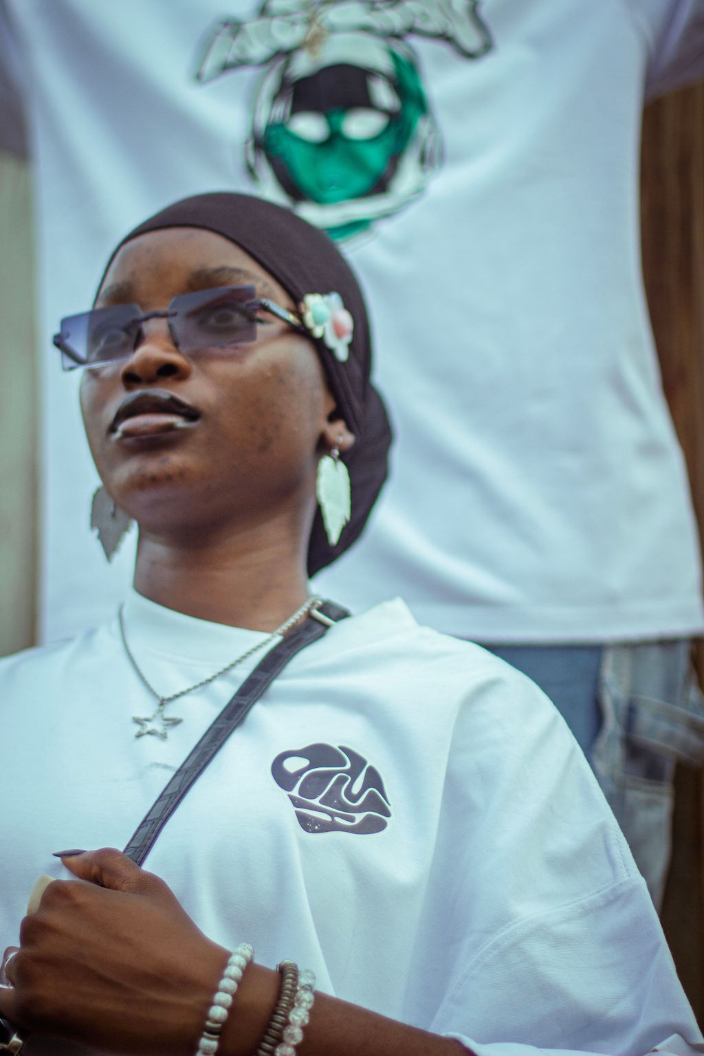 Portrait of a creative in a headwrap and branded tee
